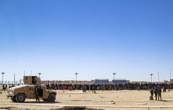 Members of the Kurdish forces stand guard during an inspection of tents at al-Hol camp in al-Hasakeh province on August 28. [Delil Souleiman/AFP]