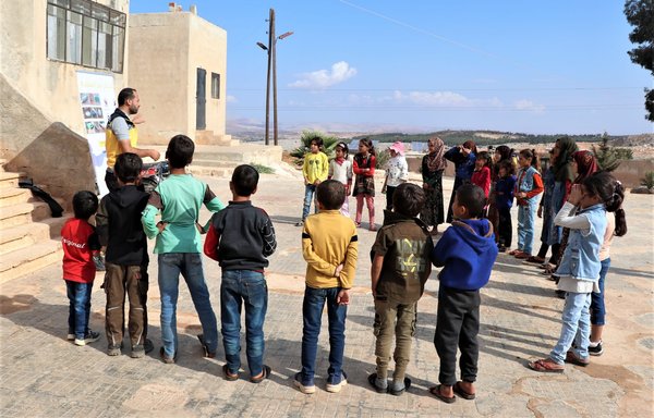 A member of the White Helmets conducts an awareness class for schoolchildren on cluster bombs on October 10. [White Helmets]
