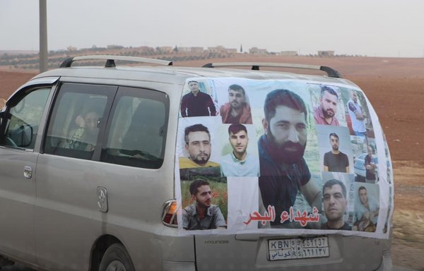 A photo montage of the Syrians who lost their lives off the coast of Algeria in October as they attempted illegal migration covers the back of a vehicle belonging to a family member of one of the deceased. [Autonomous Administration of North and East Syria]