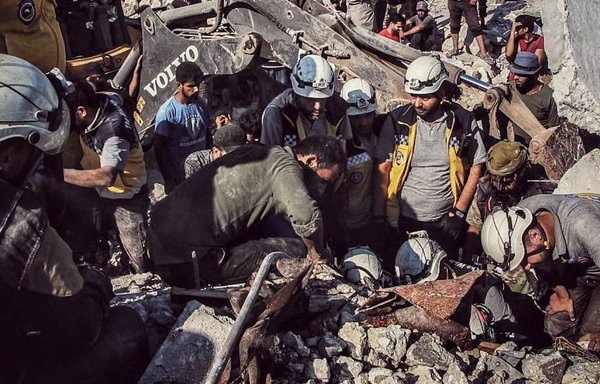Civilians and White Helmets rescuers remove the rubble of a residential building in the city of Idlib, Syria, that took a direct hit in a Russian air strike on July 14, 2019. [White Helmets]