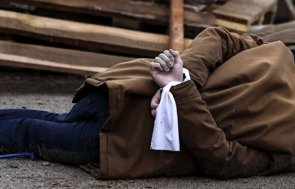 The body of a man, with his wrists tied behind his back, lies on a street in Bucha, Ukraine, just northwest of the capital Kyiv on April 2. [Ronaldo Schemidt/AFP]