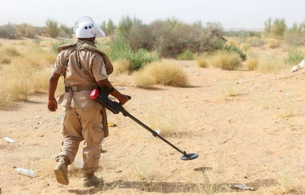 A de-mining specialist from Yemen pro-government forces clears land mines reportedly planted by the Houthis from an area on the outskirts of Bayhan in Yemen's Shabwa province on January 19, 2021. [Saleh al-Obeidi/AFP]