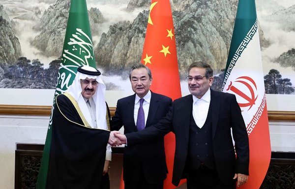In Beijing on March 10, Wang Yi, director of China's Office of the Central Foreign Affairs Commission, poses with Iran's Supreme National Security Council secretary Ali Shamkhani and Saudi national security adviser Musaad bin Mohammed Al Aiban. [Chinese Foreign Ministry]