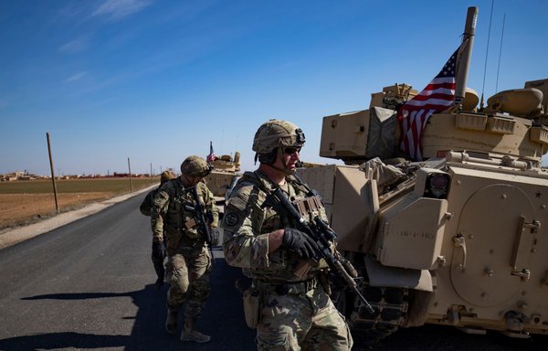 US troops patrol in the countryside of Syria's al-Hasakeh province on February 18. [Delil Souleiman/AFP]