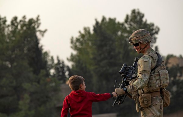 US forces patrol in the vicinity of the Hori rehabilitation centre for children of suspected ISIS elements in Syria's northeastern al-Hasakeh province, on December 15. [Delil Souleiman/AFP]