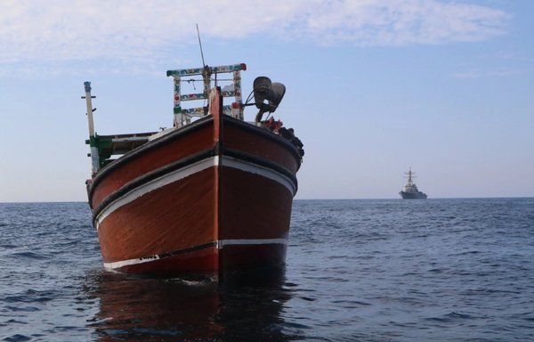 Guided-missile destroyer USS Paul Hamilton sails near a fishing vessel in the Gulf of Oman, April 21. The vessel was interdicted while attempting to smuggle illicit drugs. [US Navy]