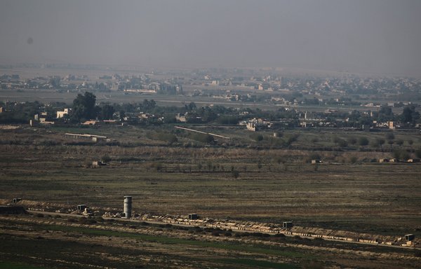 صورة التقطت في 12 نوفمبر/تشرين الثاني 2018 بمدينة القائم العراقية، تظهر فيها بلدة البوكمال الحدودية في محافظة دير الزور السورية. [أحمد الربيعي/وكالة الصحافة الفرنسية]