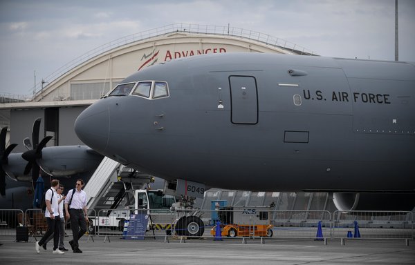 Visitors walk past a US Air Force Boeing KC-46 Pegasus during the International Paris Air Show at the Paris–Le Bourget Airport on June 18. [Julien de Rosa/AFP]